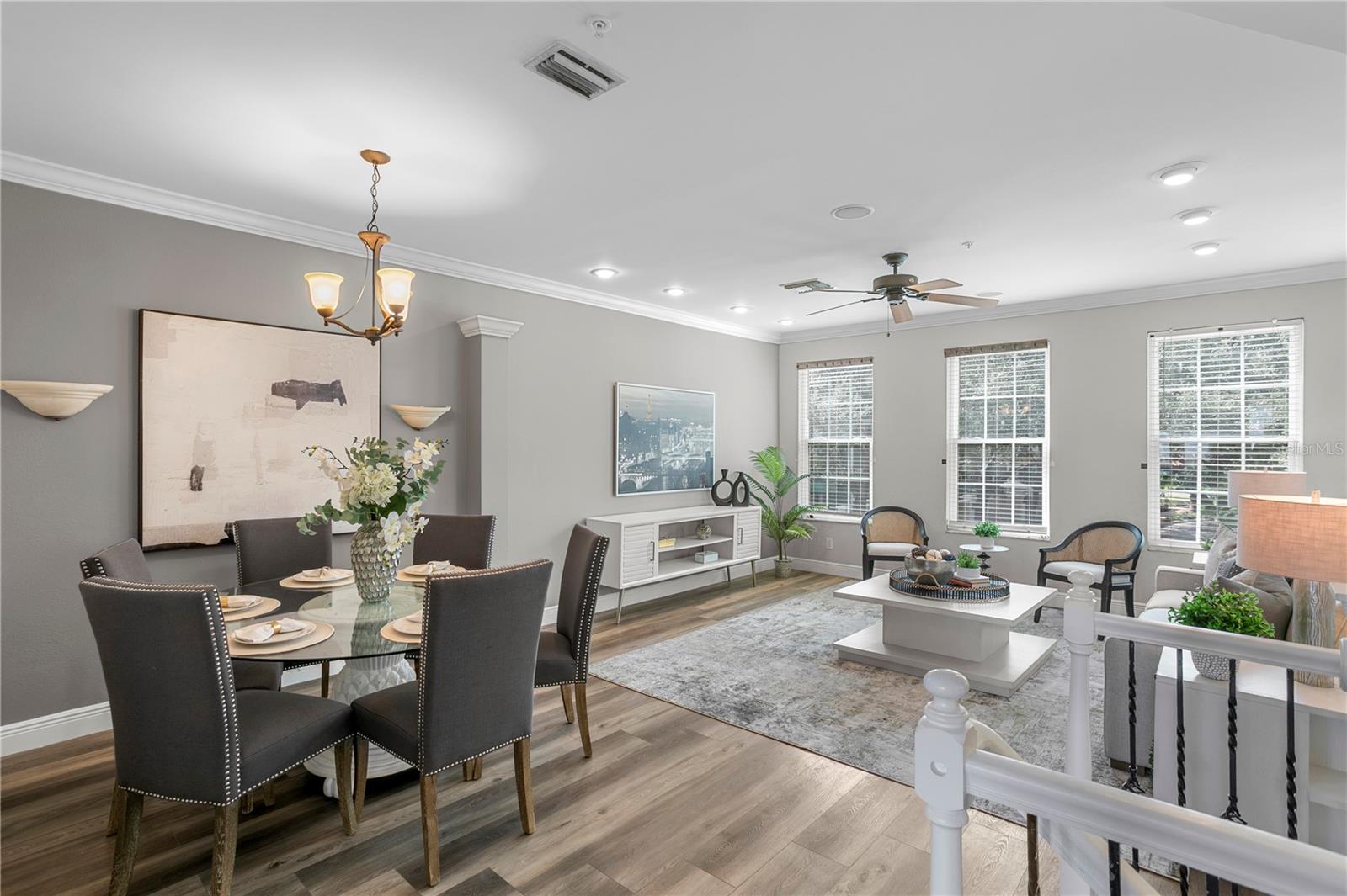 An open and inviting living room with space for dining filled with beautiful natural light.