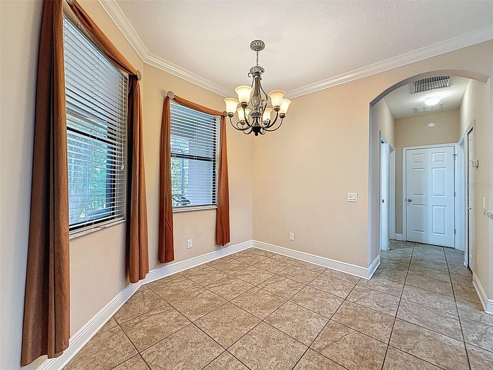 Spacious breakfast nook overlooking the backyard landscape