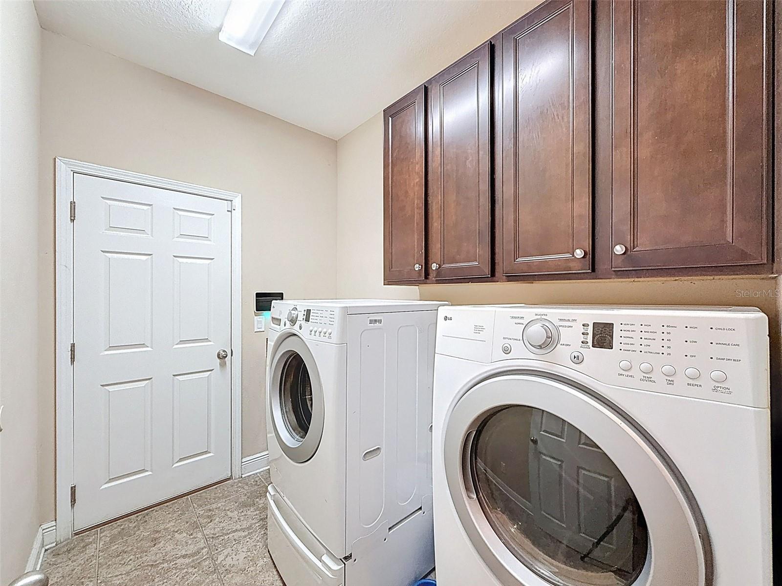 Awesome utility room and cherry cabinetry for additional storage