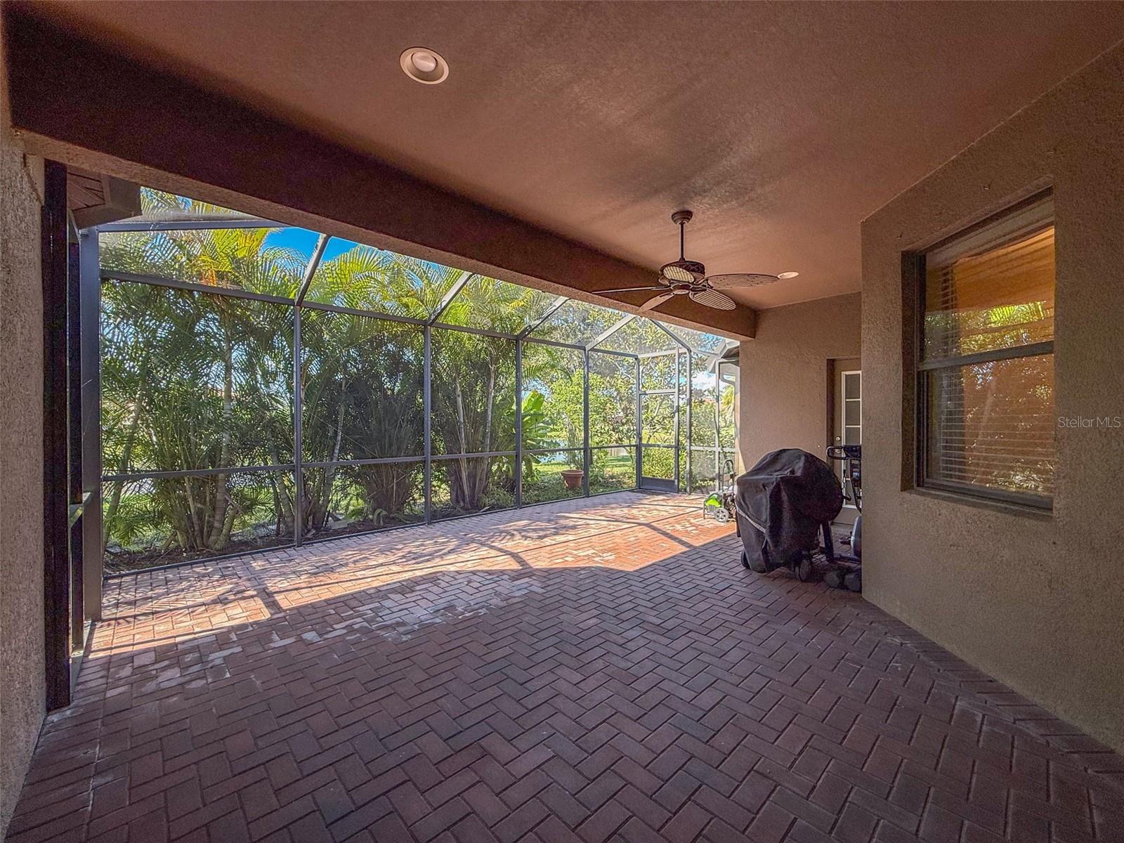 Enclosed back patio with triple sliding glass doors to the main part of the home and to the kitchen