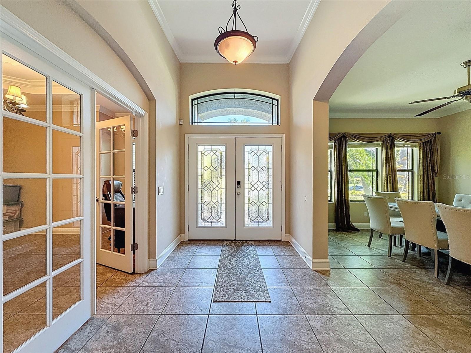 Grand entryway with gorgeous leaded glass double doors and transom window for extra bright light!