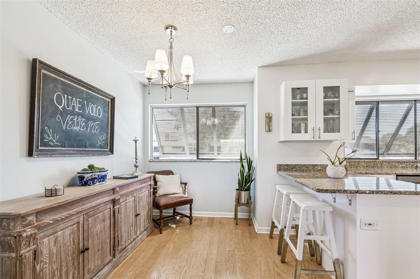 The dining room leads into a breakfast nook with bar...