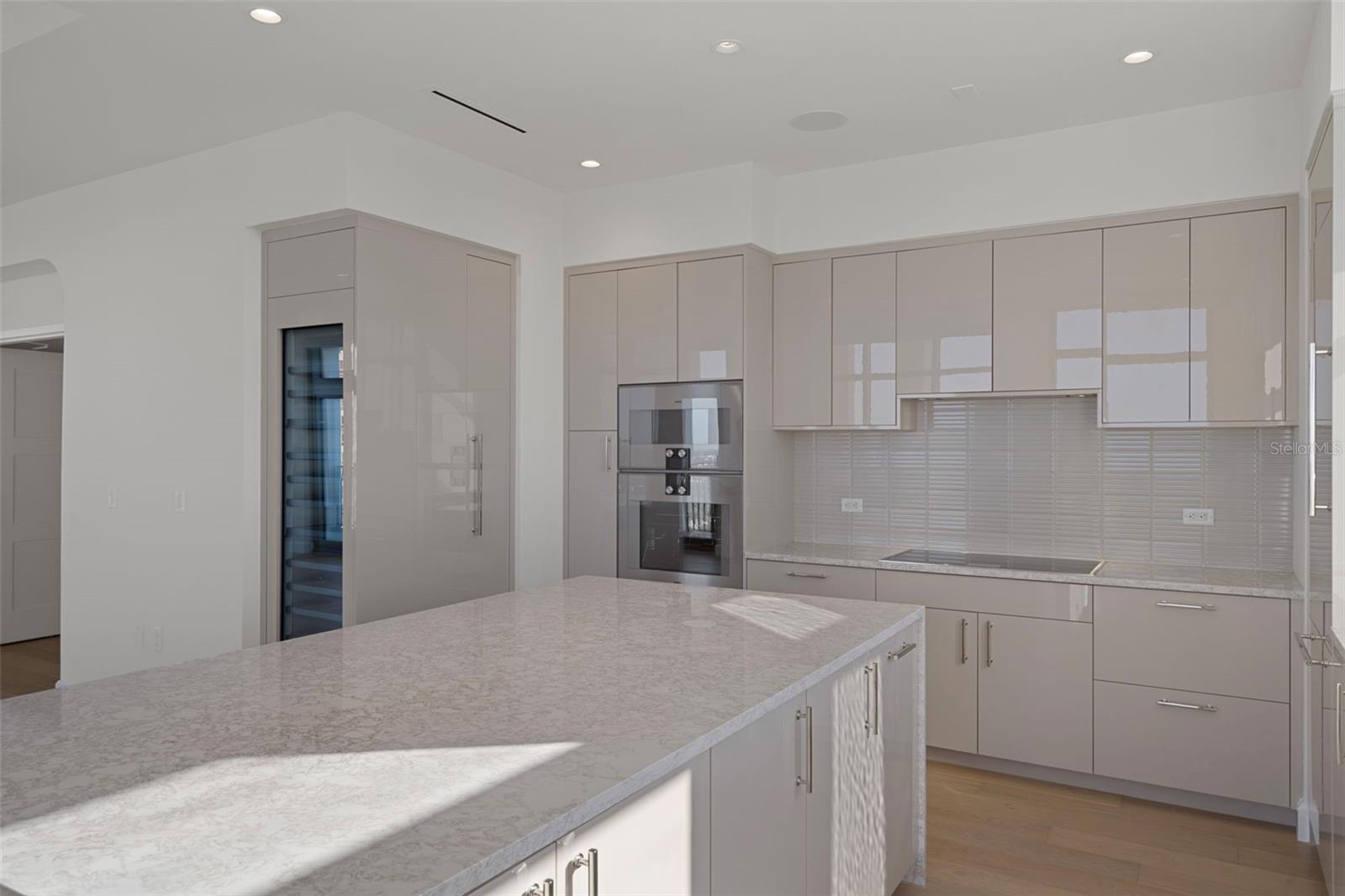 Waterfall quartz island with abundant counter space.