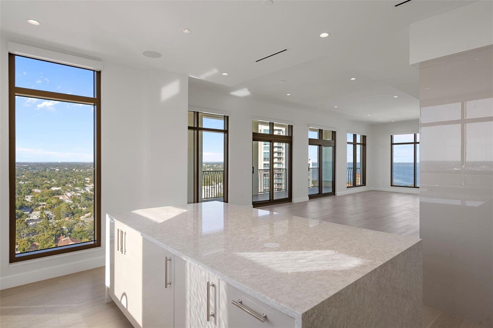 Open-concept dining with bay and city views