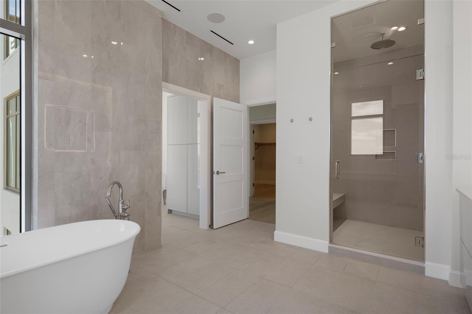 Spa-like bath with soaking tub and rain shower.