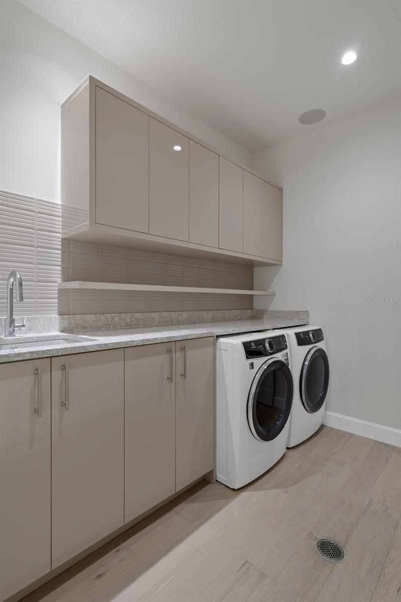 Oversized laundry with a folding counter and storage.