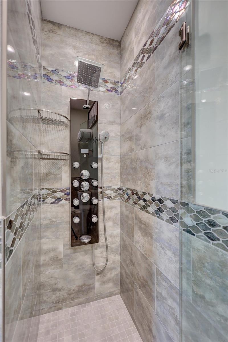 Beautifully tiled shower in the primary suite