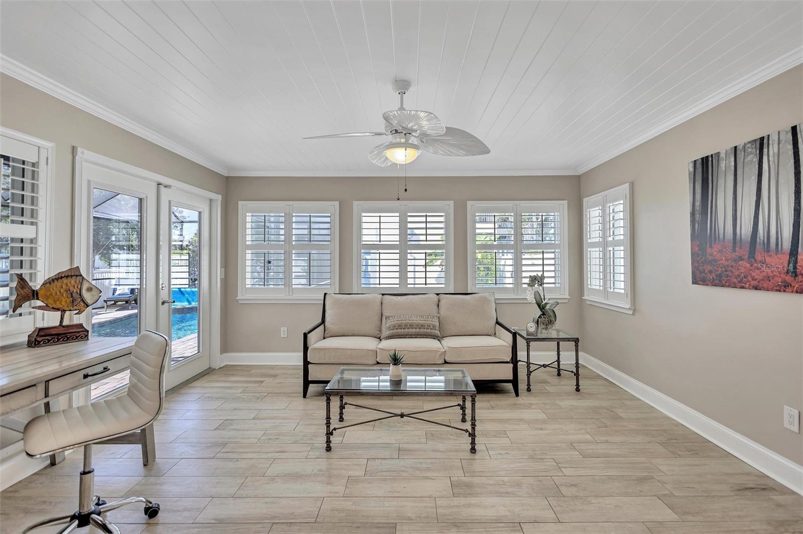 This beautiful flex space opens to the Lanai and pool!