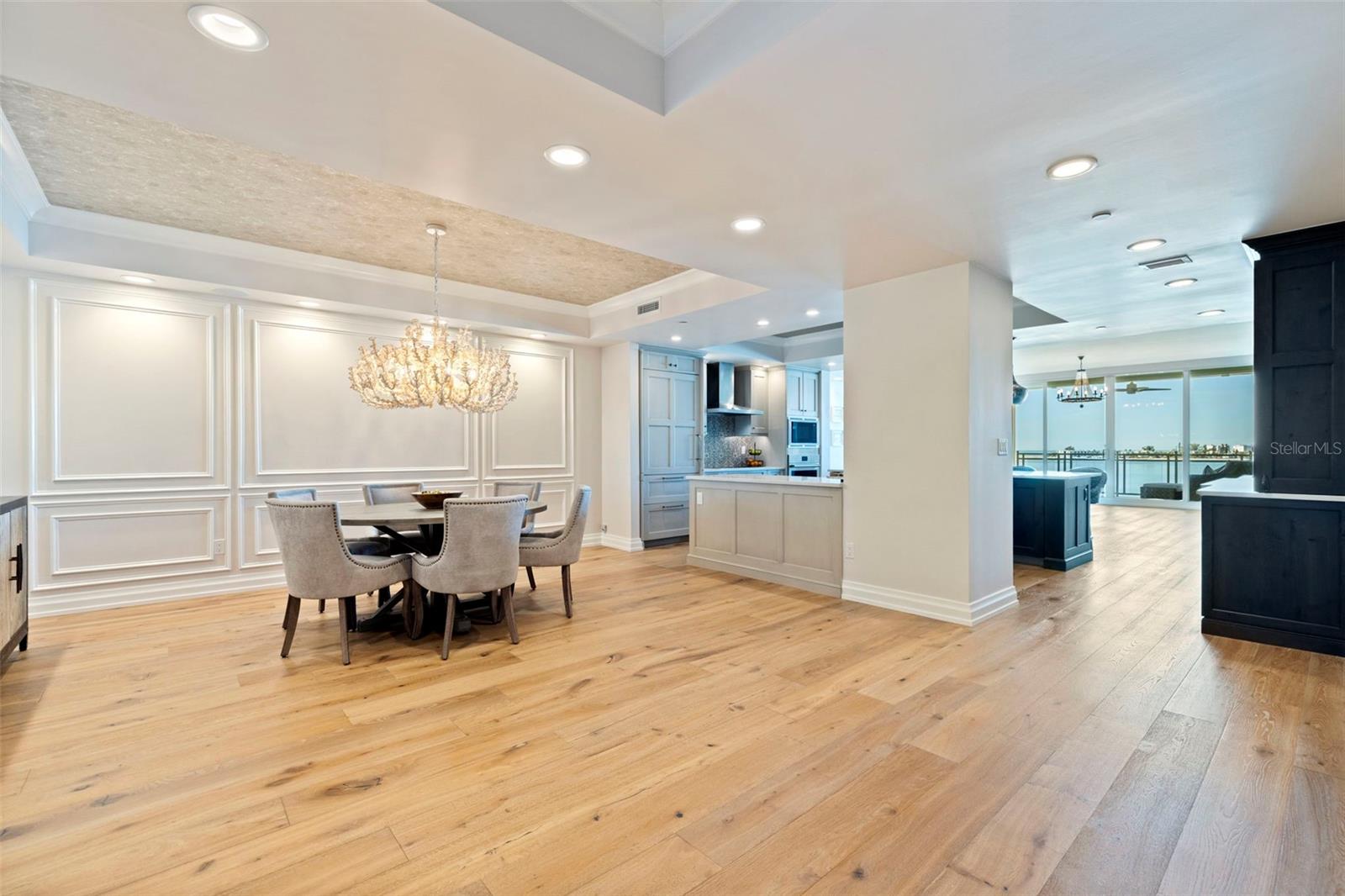 Stunning dining room with designer wallpaper on the ceiling.
