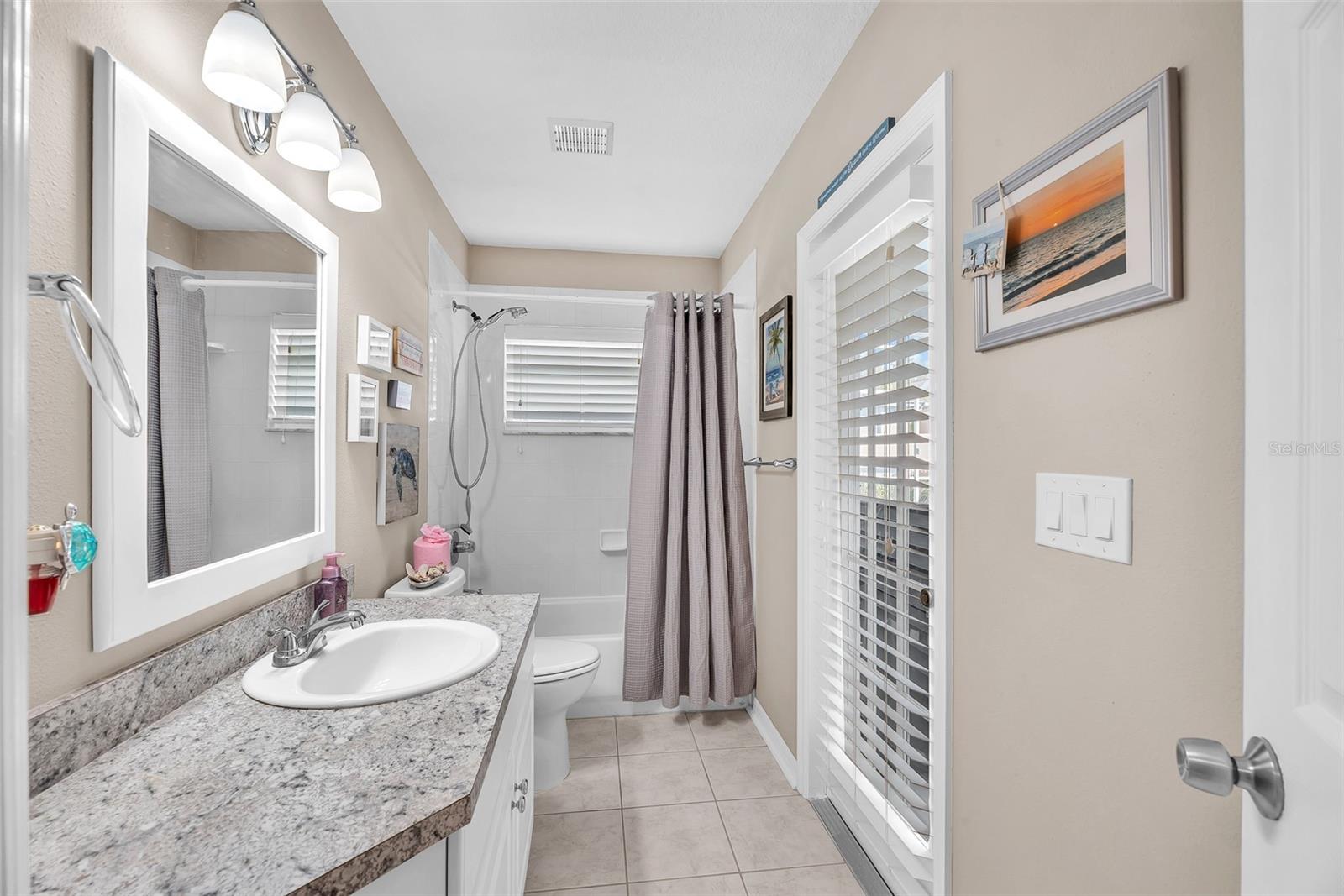 The secondary bathroom with tub/shower combination that also has pool access for convenience.