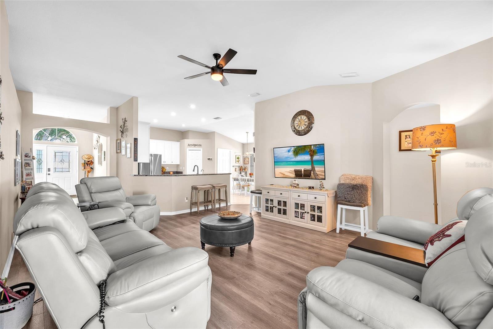 Bright and open great room with LVT flooring, high ceilings and a seamless connection to the kitchen.
