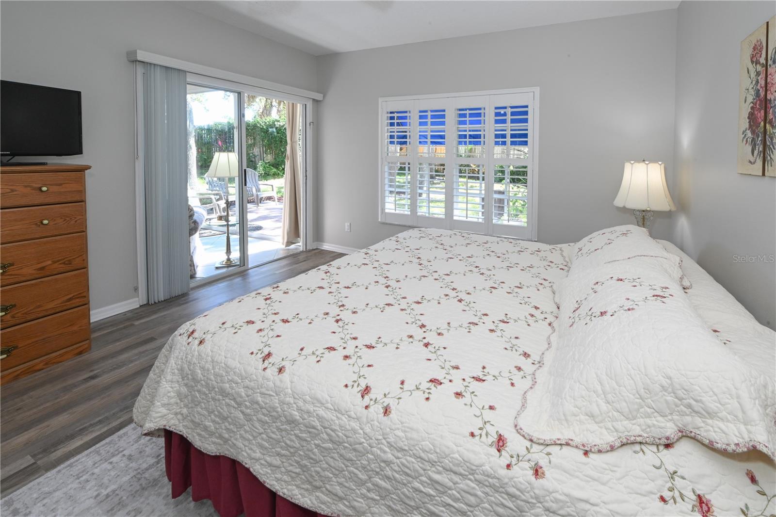 Master Bedroom with Window & Shutters, Slider Access to Florida Room, Backyard.
