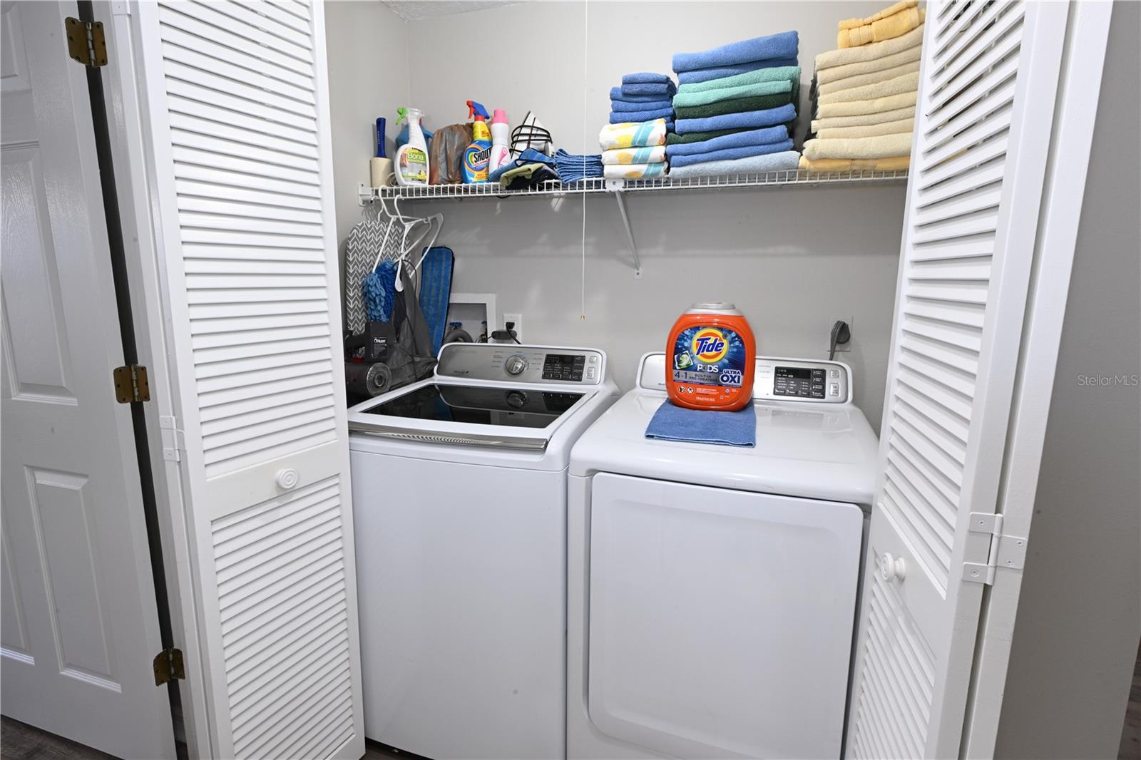 Laundry Closet with Wash/Dryer & Storage Shelf.
