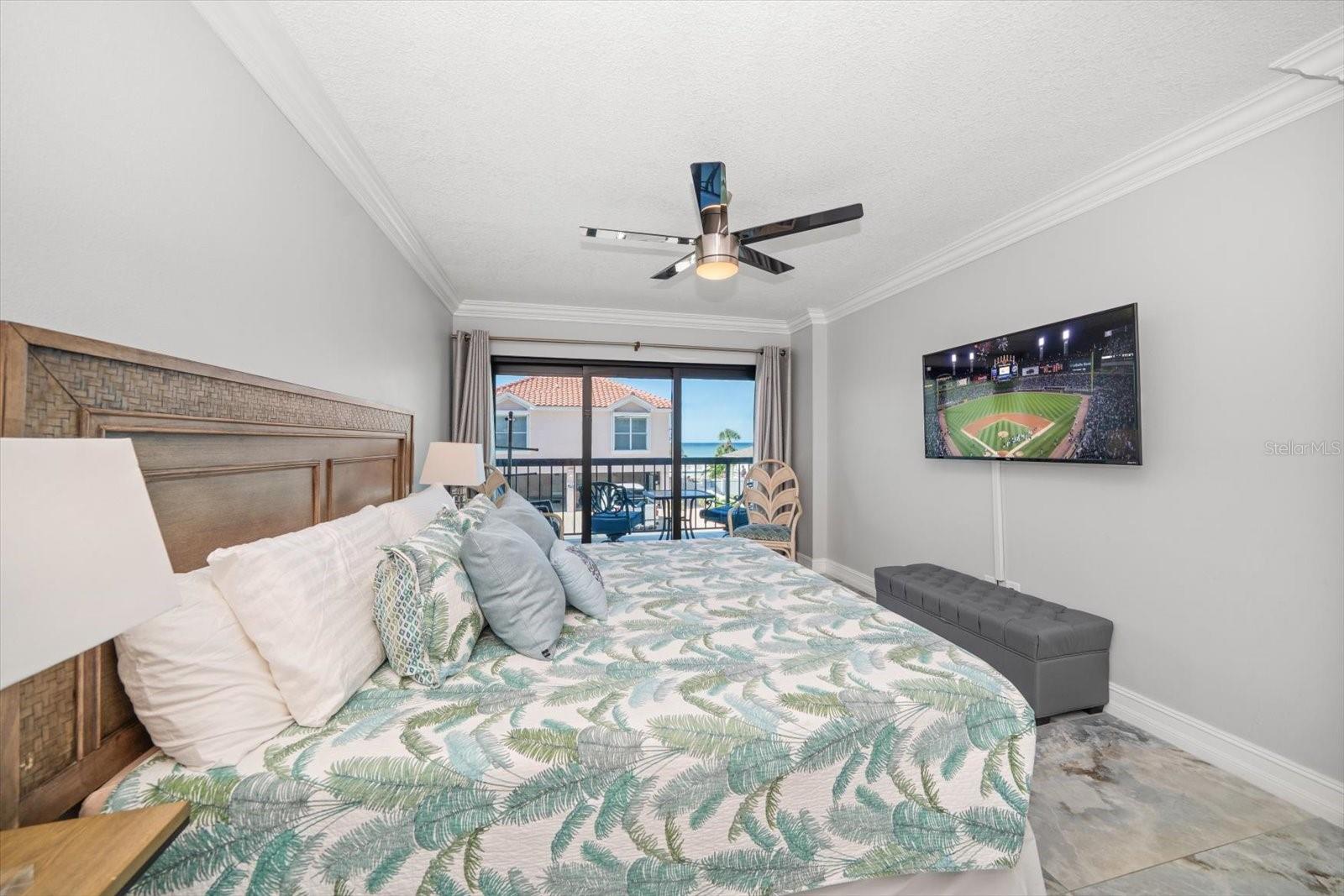 Primary bedroom with access to expansive terrace.