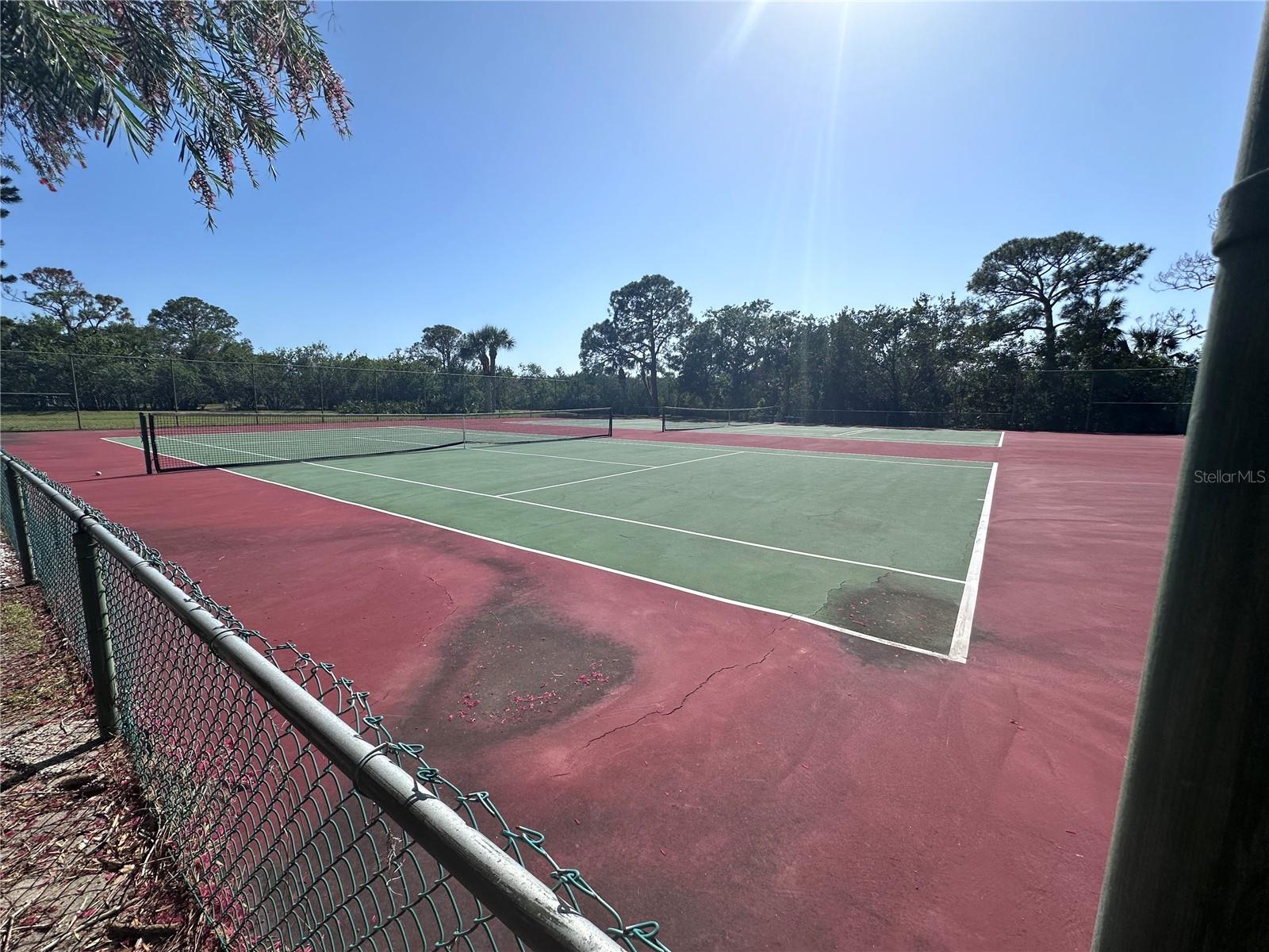 Two tennis courts, one of which has the pickleball lines painted on