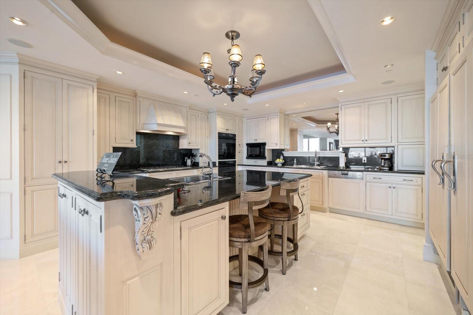 The kitchen is designed for peak performance with its prep areas, center island, double wall oven; all appliances are integrated into the cabinetry