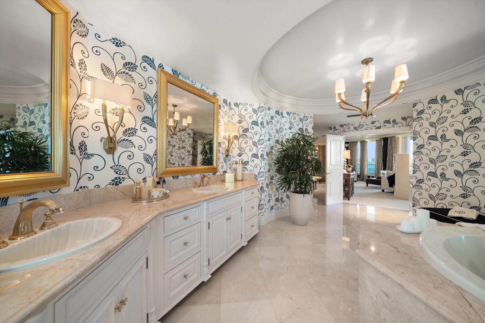 The primary bathroom is outstanding-boasting space- areas for relaxation, dressing and privacy.