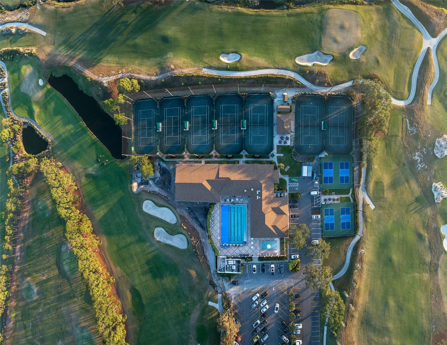 Overhead view of recreational area for tennis, pickleball, fitness center, and pool/aquatic area.