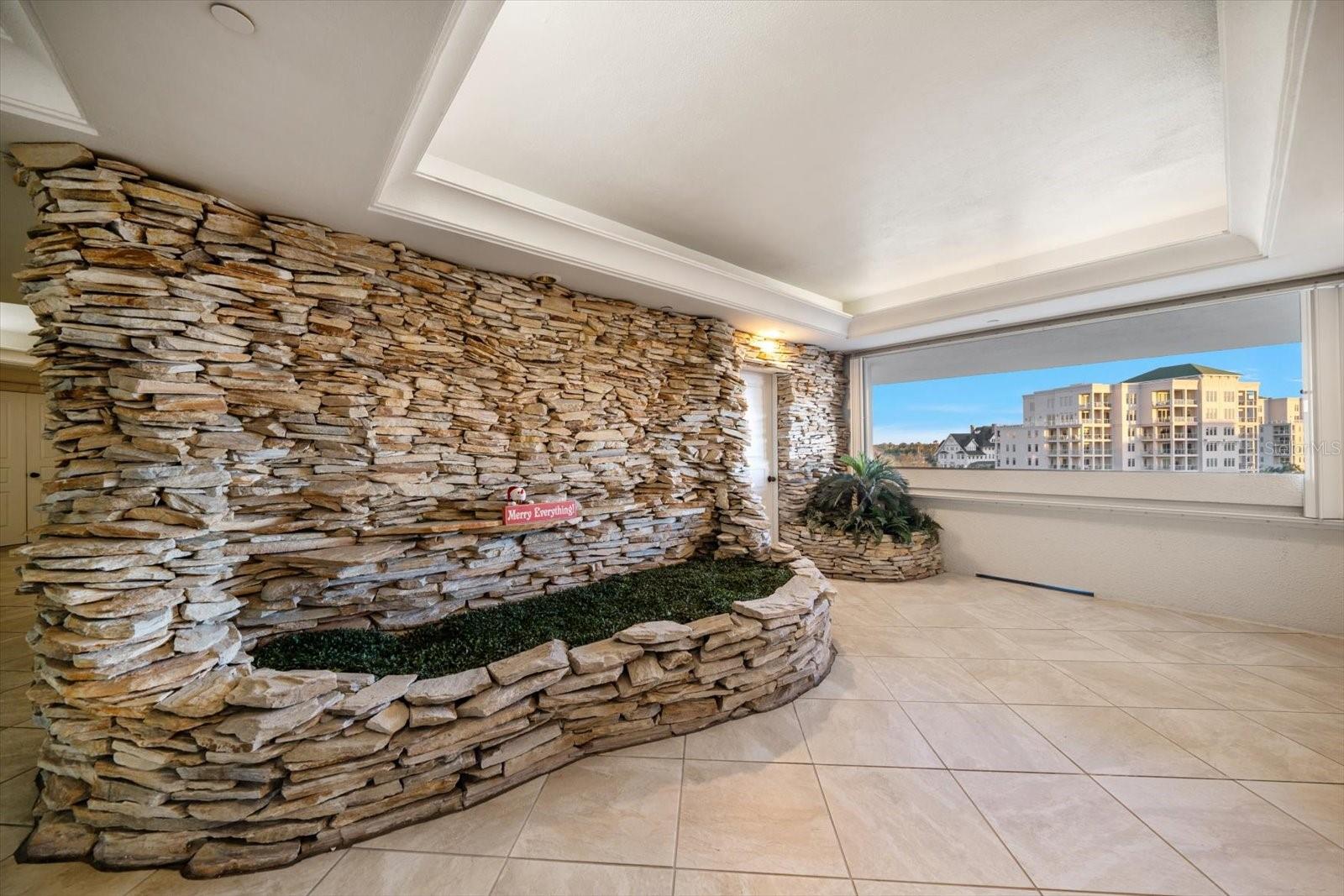 Waterfall wall feature enhances the private entry.