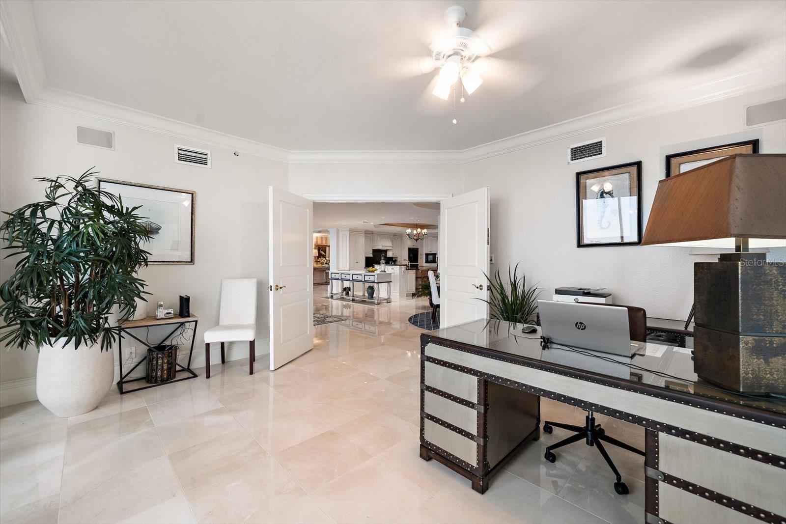 The fourth bedroom, found adjacent to the kitchen and dining areas, is currently used as an office space, offering a private ensuite bath, walk-in closet, and private access to the balcony.