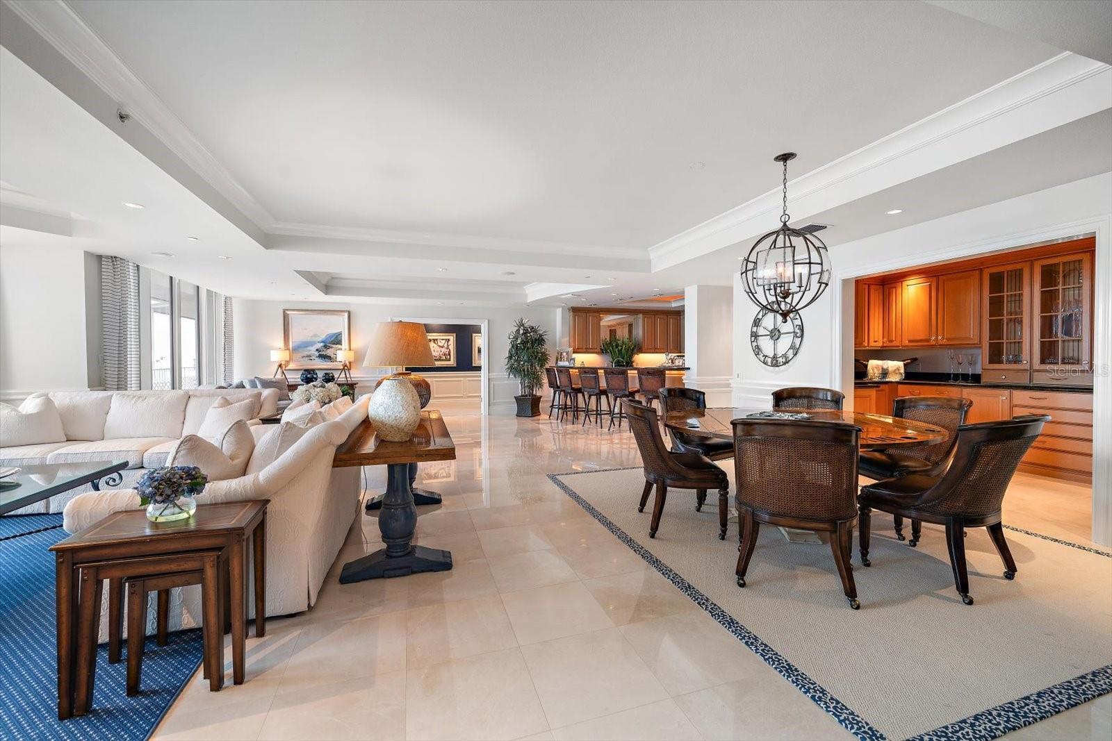 Quiet and comfortable living areas are found throughout, from the family room framed by floor-to-ceiling windows to an intimate area for games and gatherings off the butler's pantry.
