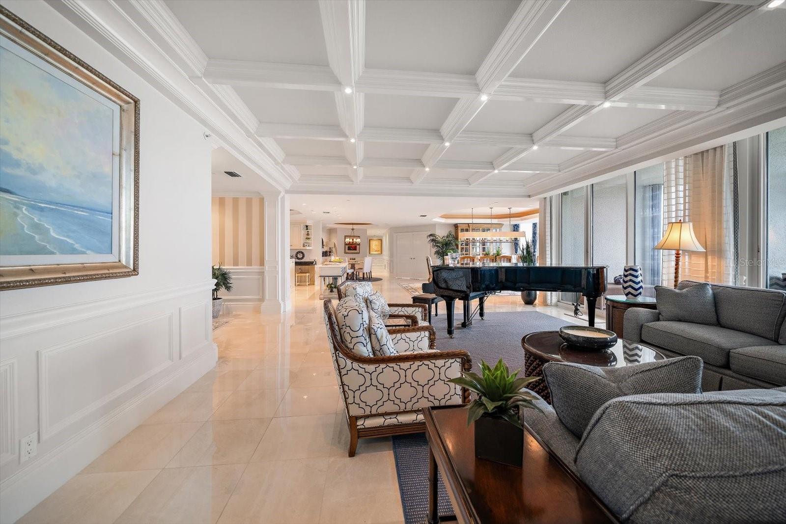 Designed for both grand entertaining and everyday living, the space showcases coffered ceilings, gleaming marble floors, and custom millwork that reflect timeless craftsmanship.