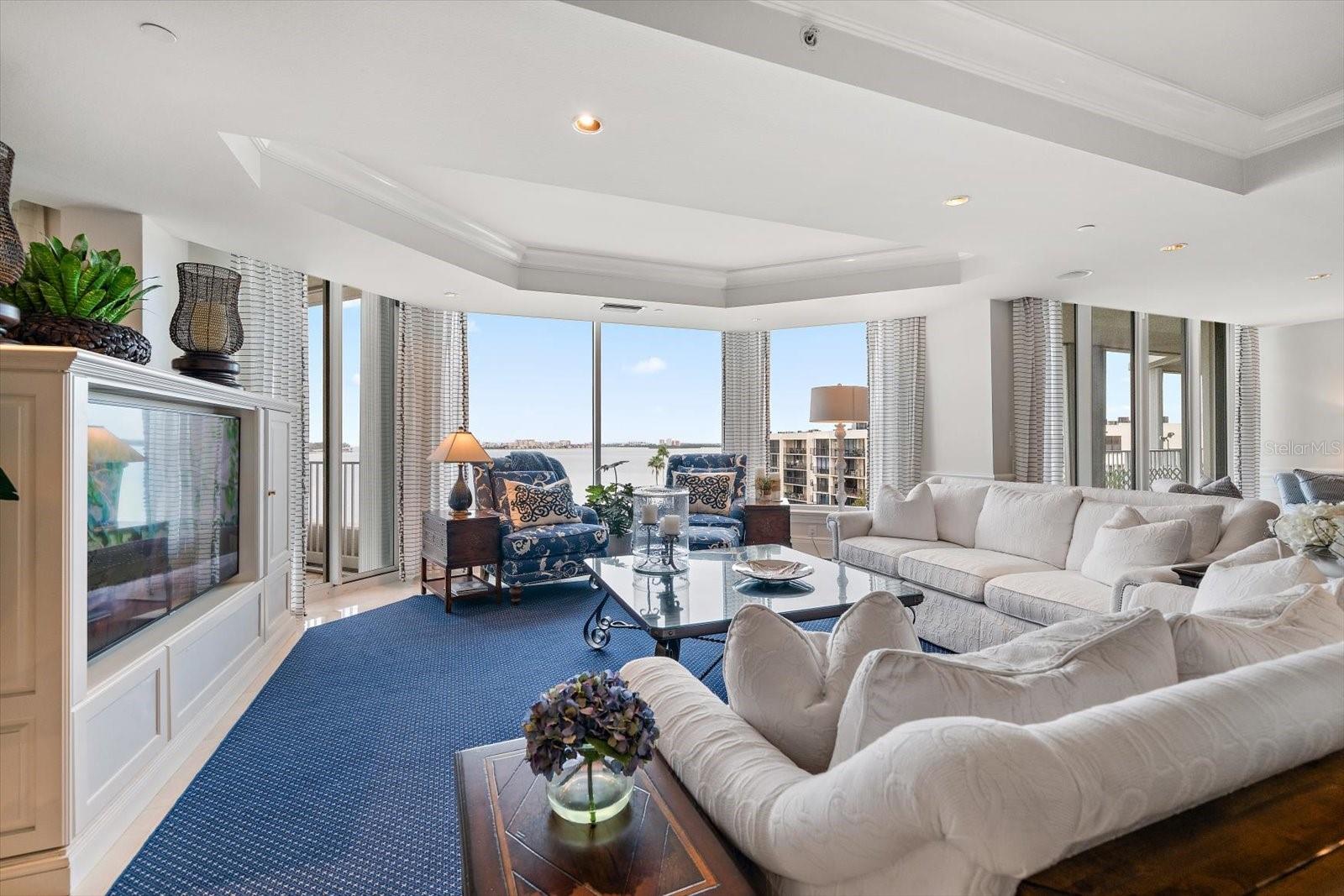 The Gulf-front family room is a bright and inviting space designed for relaxed coastal living. Expansive floor-to-ceiling windows frame sweeping open-water views, filling the room with natural light and capturing the beauty of the shoreline beyond.