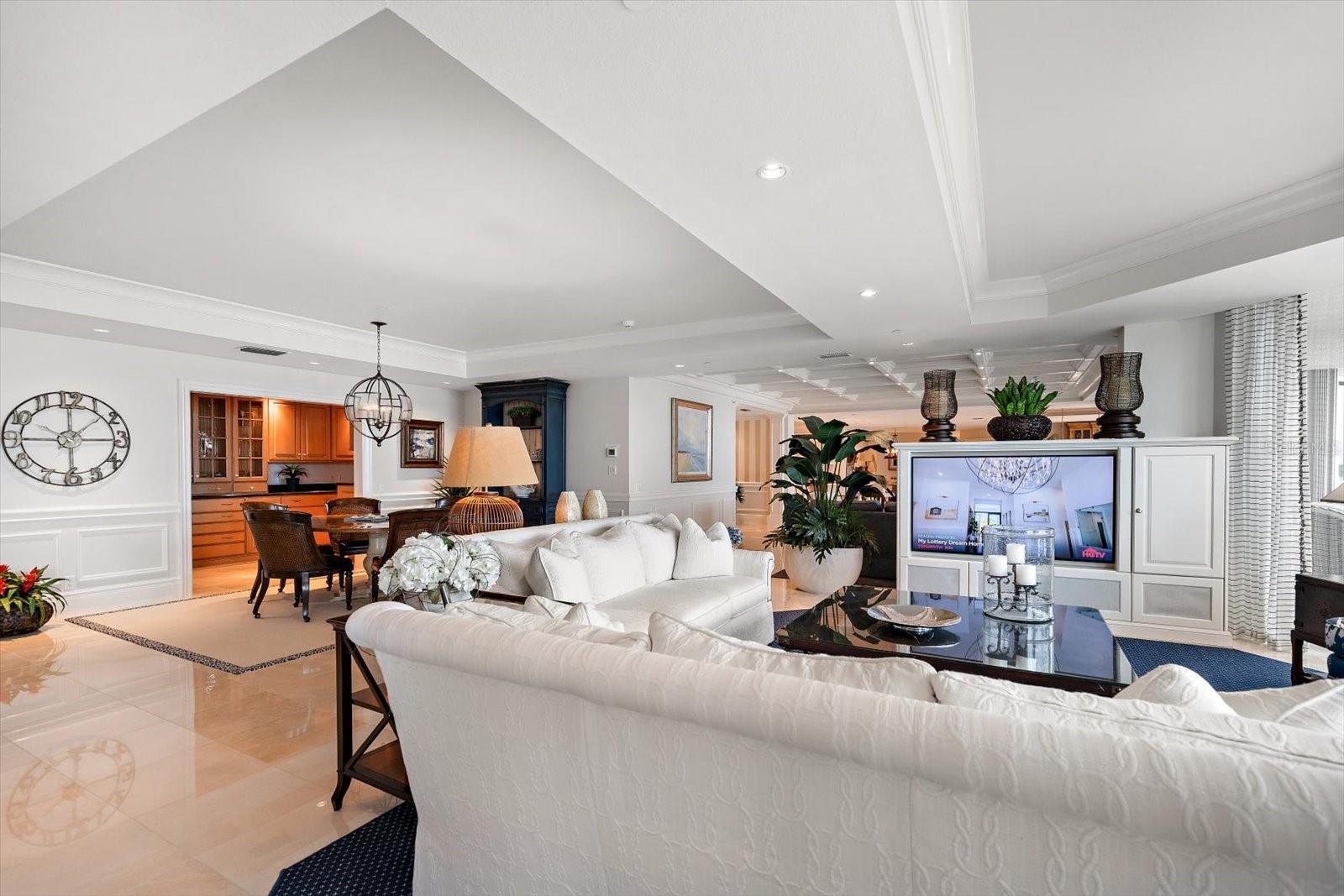 Elegant tray ceilings, custom window treatments, and refined architectural details complement the comfortable, sophisticated furnishings.