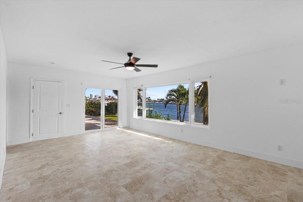 Primary Bedroom with Hurricane Sliding Doors to Backyard and Patio.