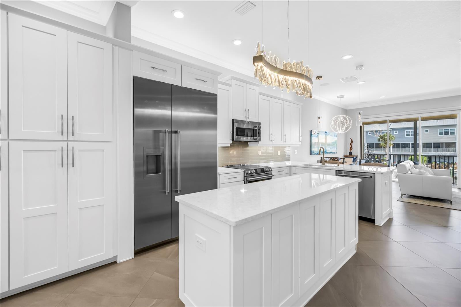 Custom Kitchen featuring 7' Island, Thermador refrigerator and induction range