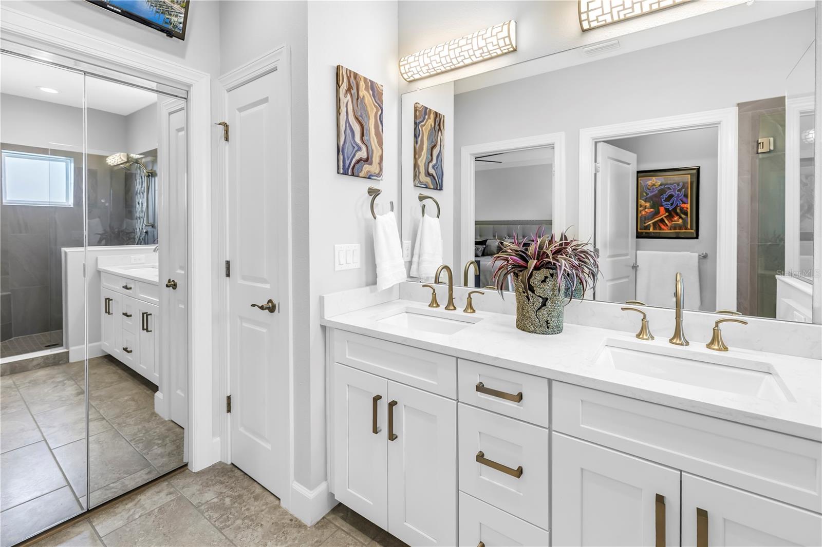 Primary bath with custom bi-fold mirrored closet door