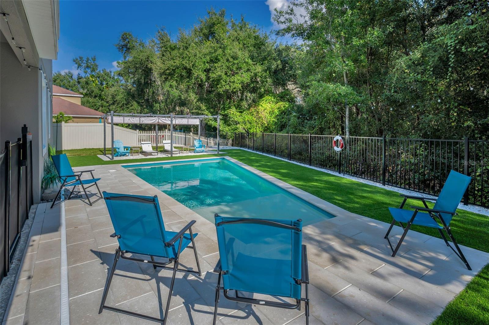 pool, beach area pergola, and rear fence