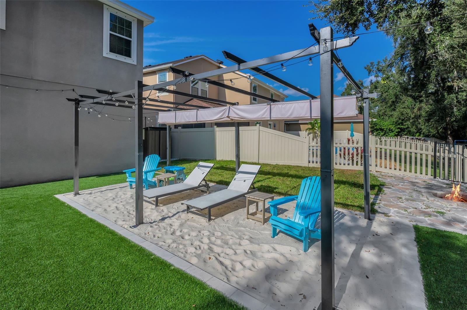 beach area pergola, fire pit, and shed