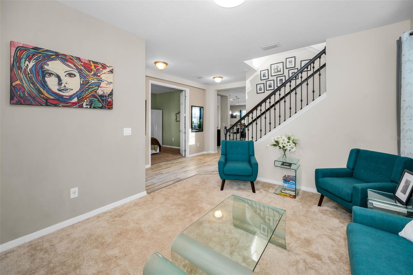 living room looking toward the staircase and den