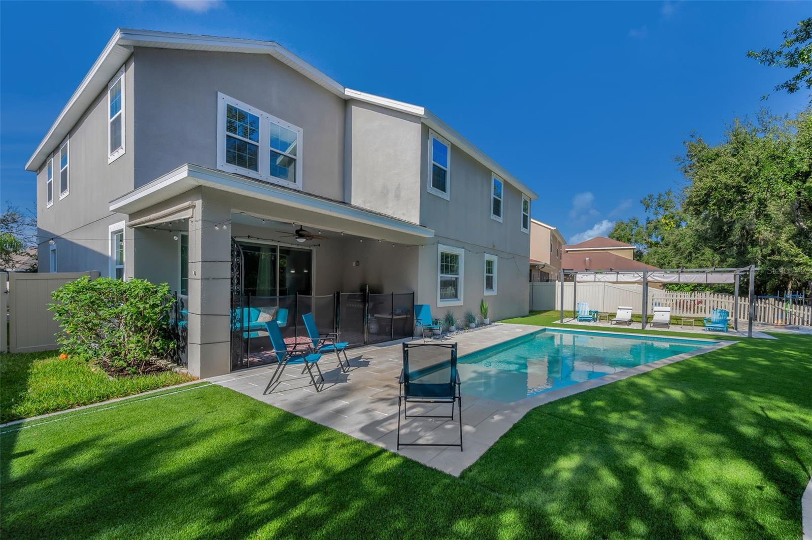 rear of home, lanai, pool, and beach area pergola