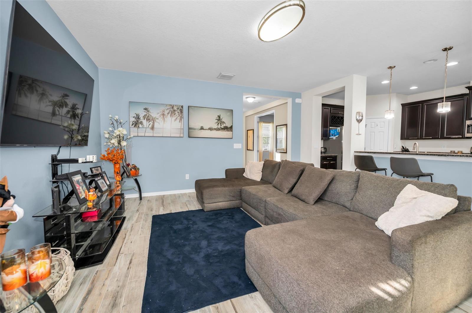 family room looking back toward the den, and the kitchen