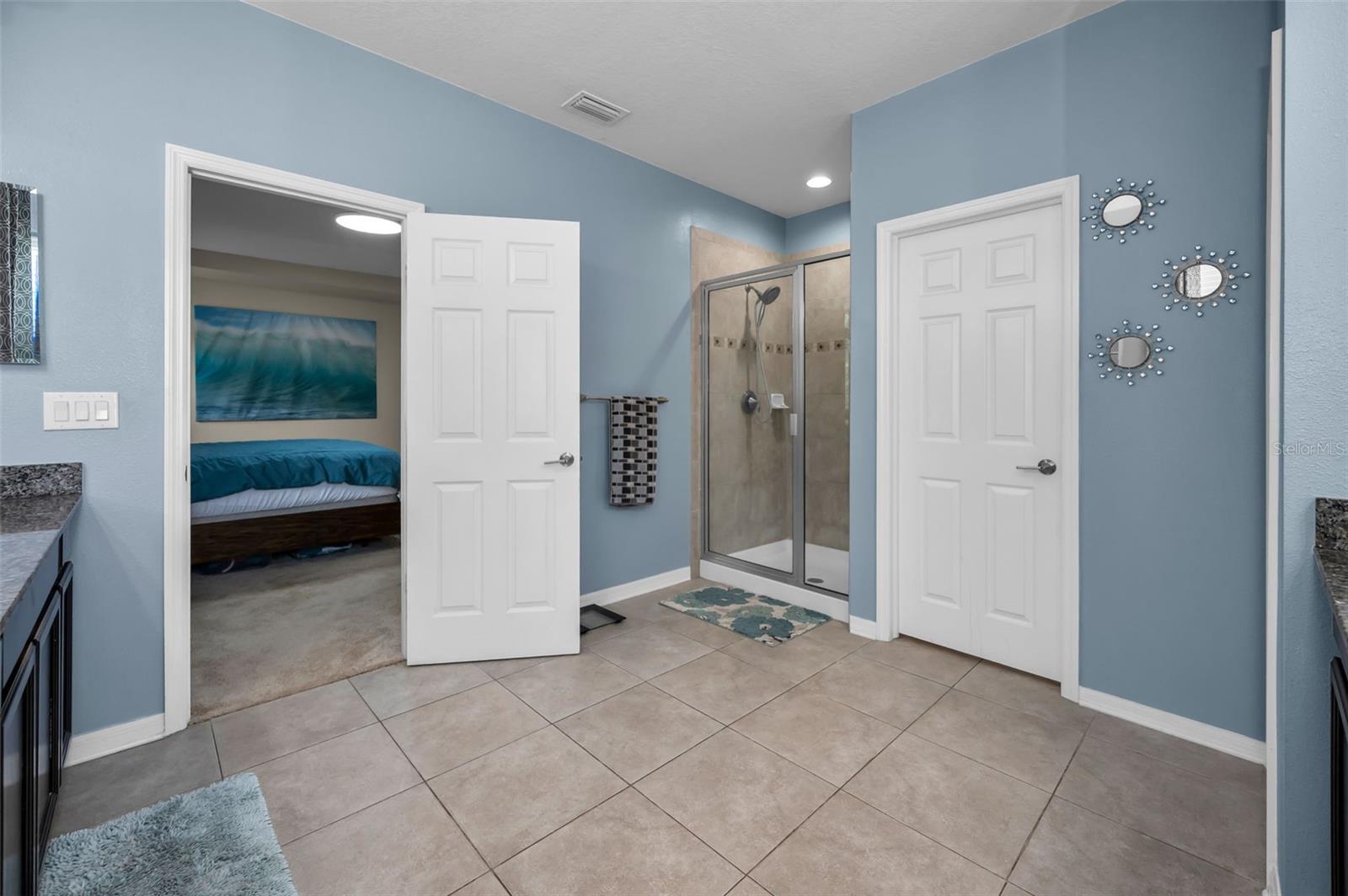 primary master bathroom, walk-in shower, water closet, looking toward the primary master bedroom
