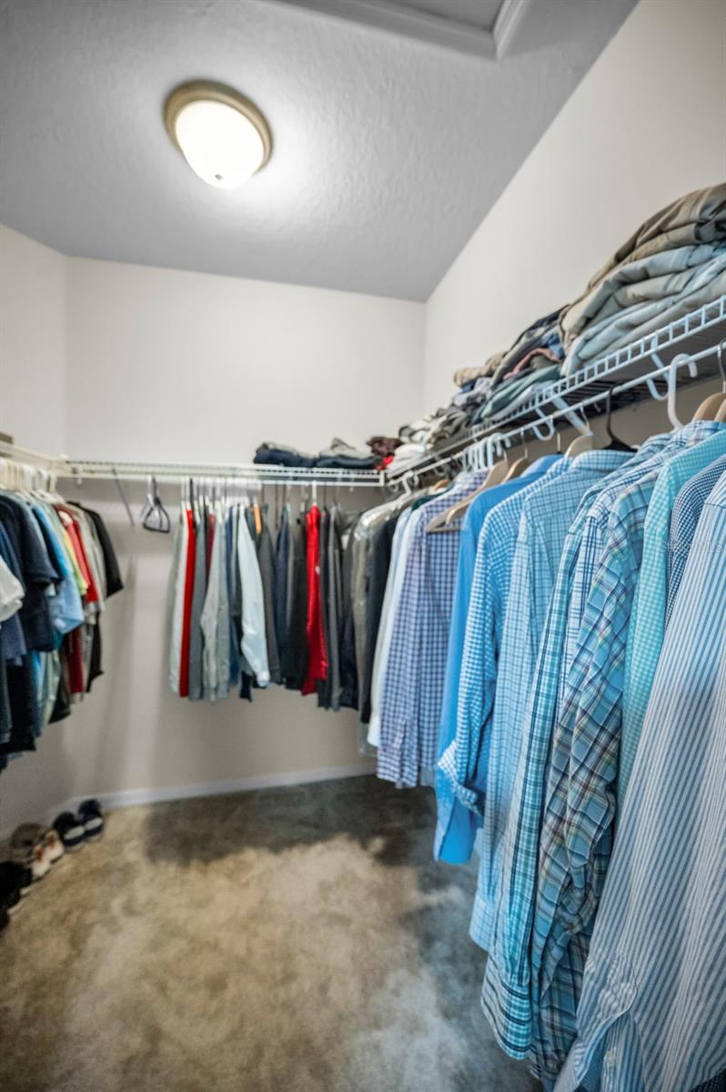 1 of 2 primary master bedroom walk-in closet
