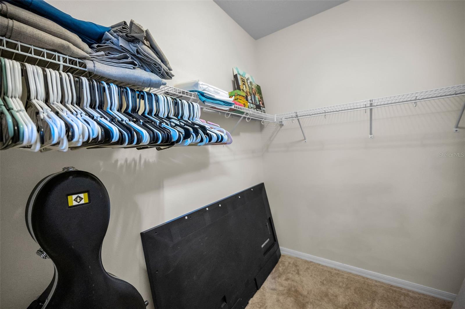 1 of 2 primary master bedroom walk-in closet
