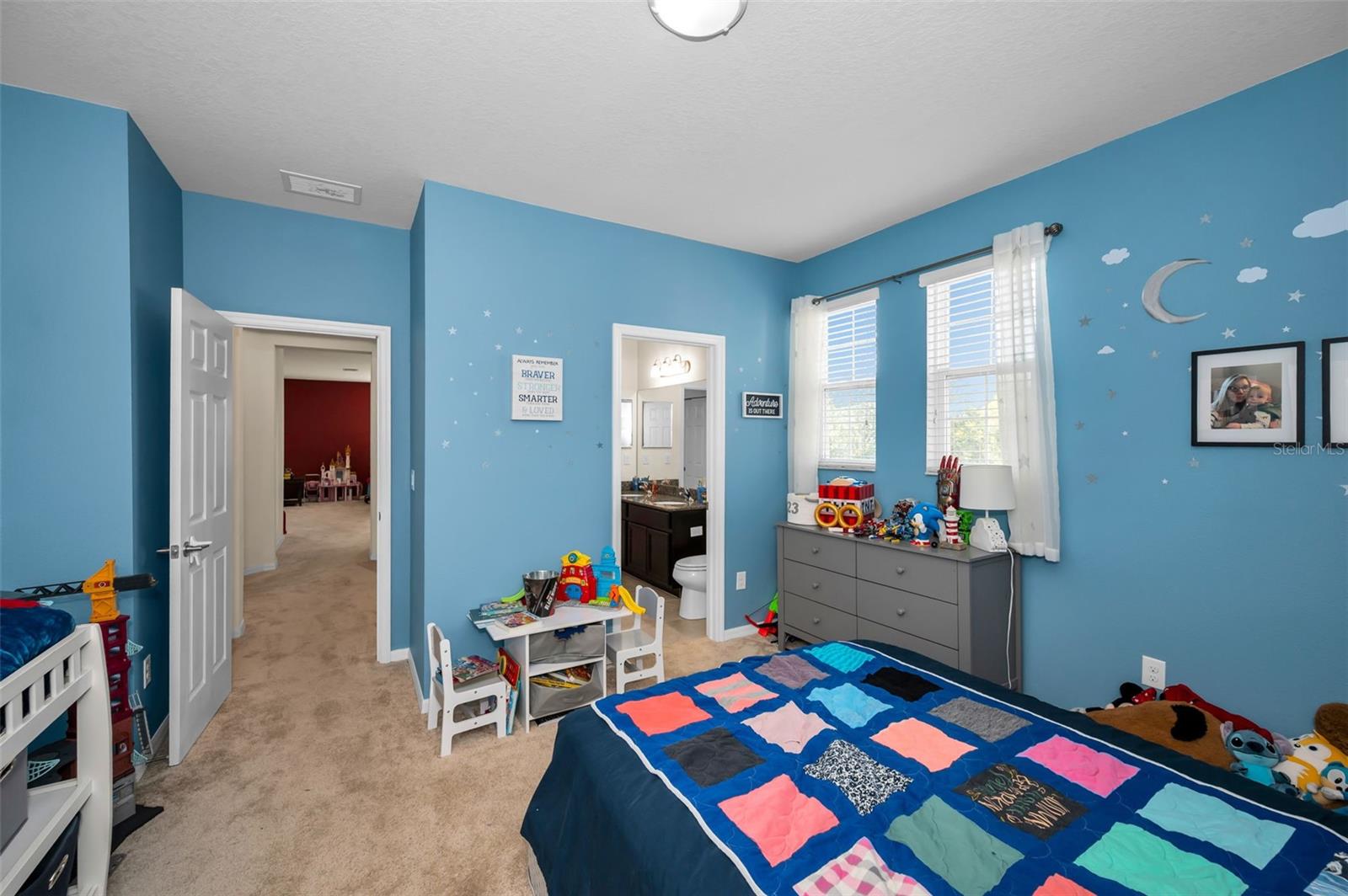 1 of 2 of the Jack/Jill bedrooms looking to its entrance and the shared Jack/Jill bathroom