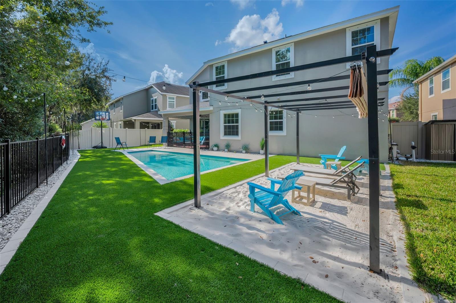 beach area pergola, pool, rear of home, lanai, shed, and pool equipment