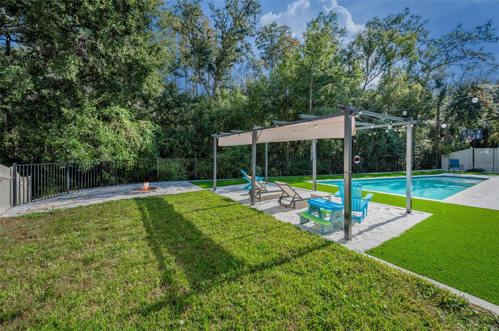 beach area pergola, pool, and fire pit