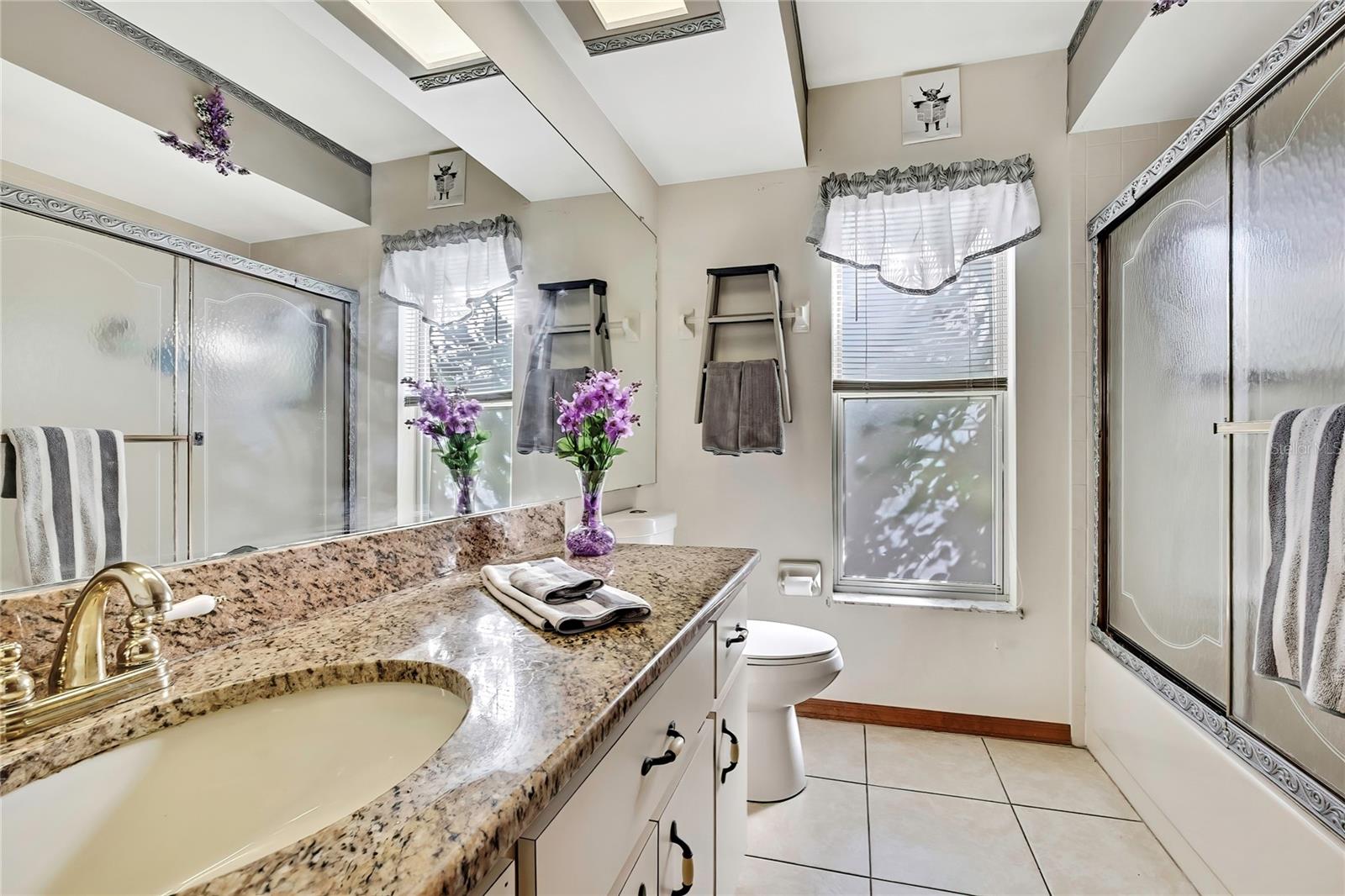 Hall Bath with shower/tub combo, granite top