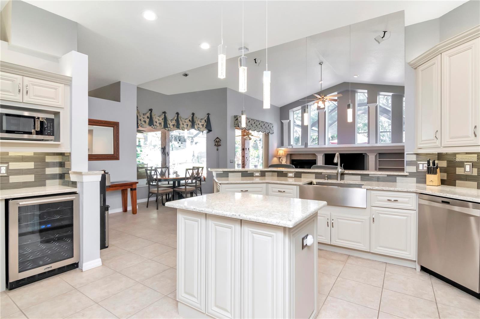Updated Kitchen with wine fridge, stainless steel appliances and open to the family room and pool views.