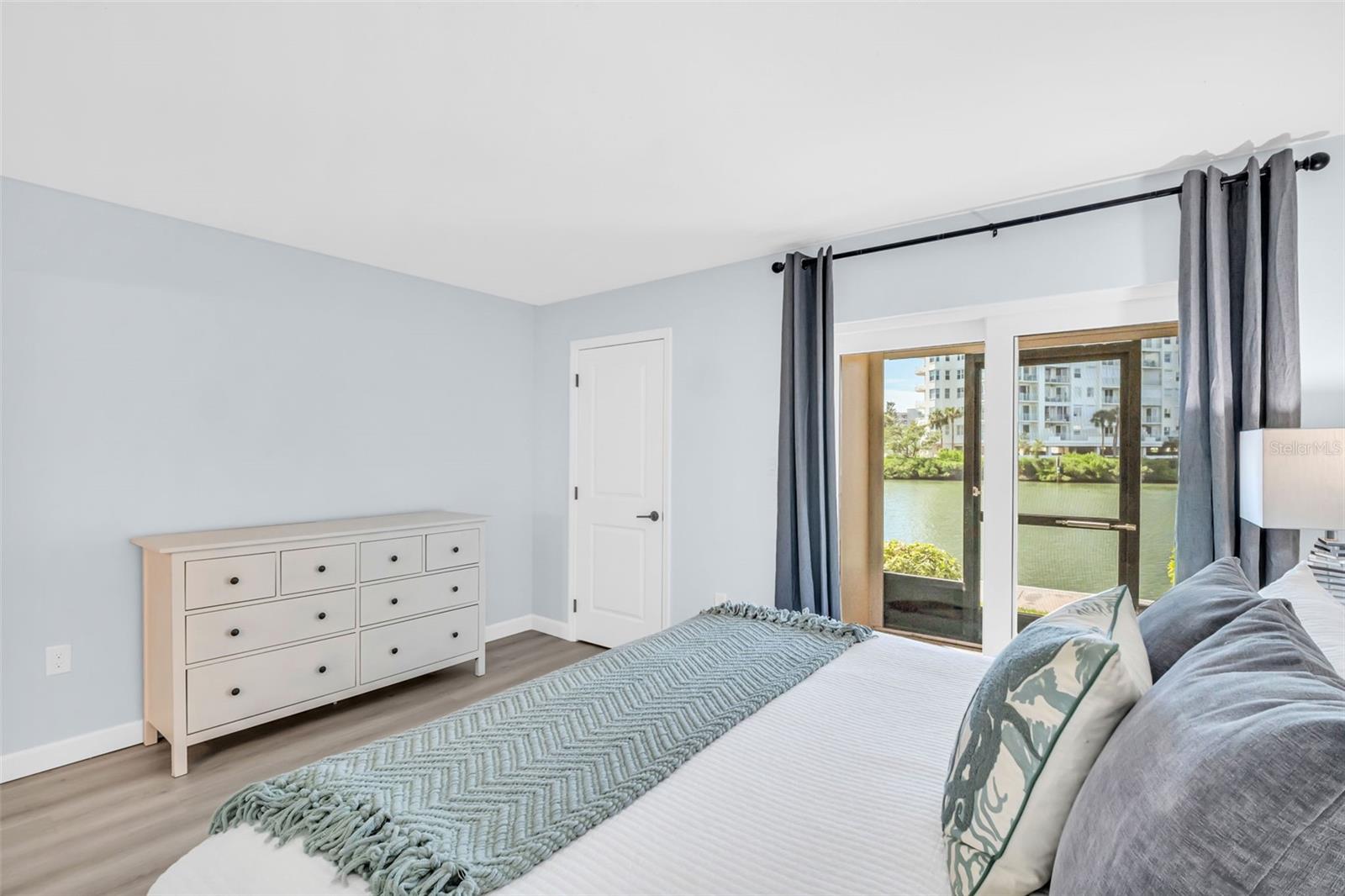 Primary bedroom has covered porch with water views