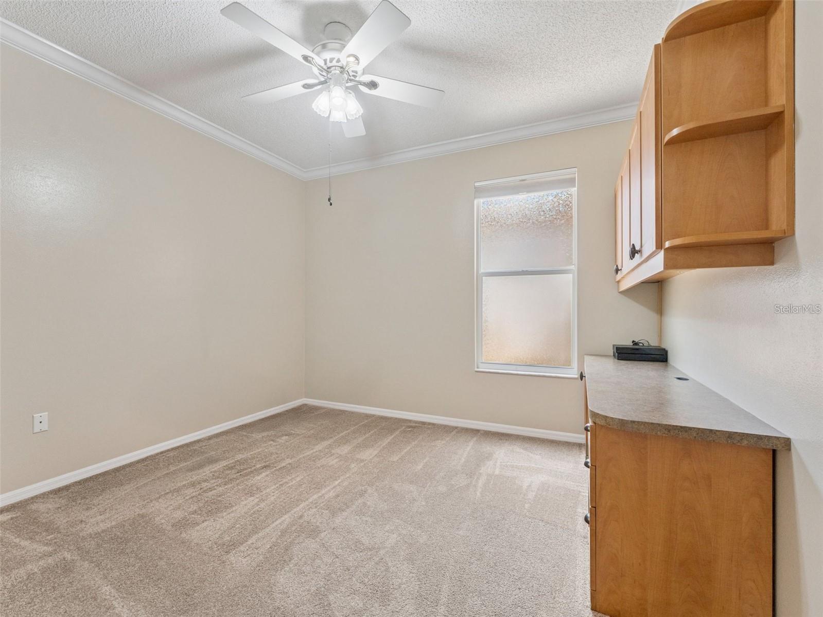 2nd bedroom with extra built in storage, could be used as a bedroom, office or den.