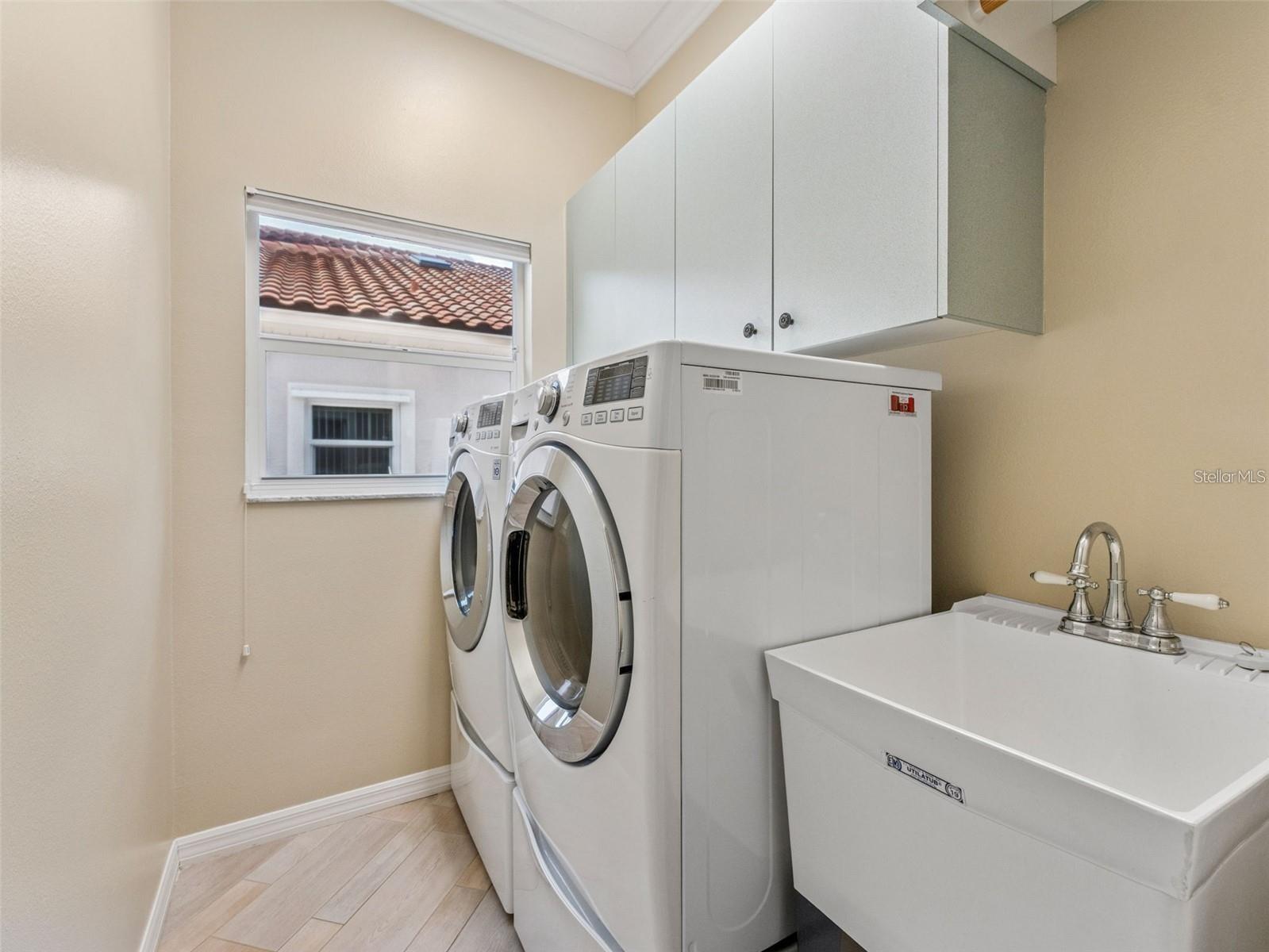 Laundry room with new washer and dryer included and utility sink