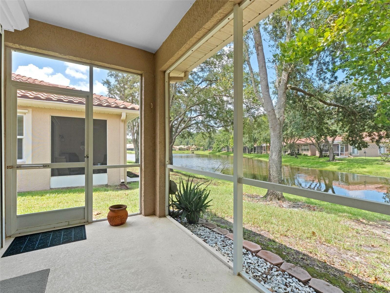 Back patio is screened in with views of the pond