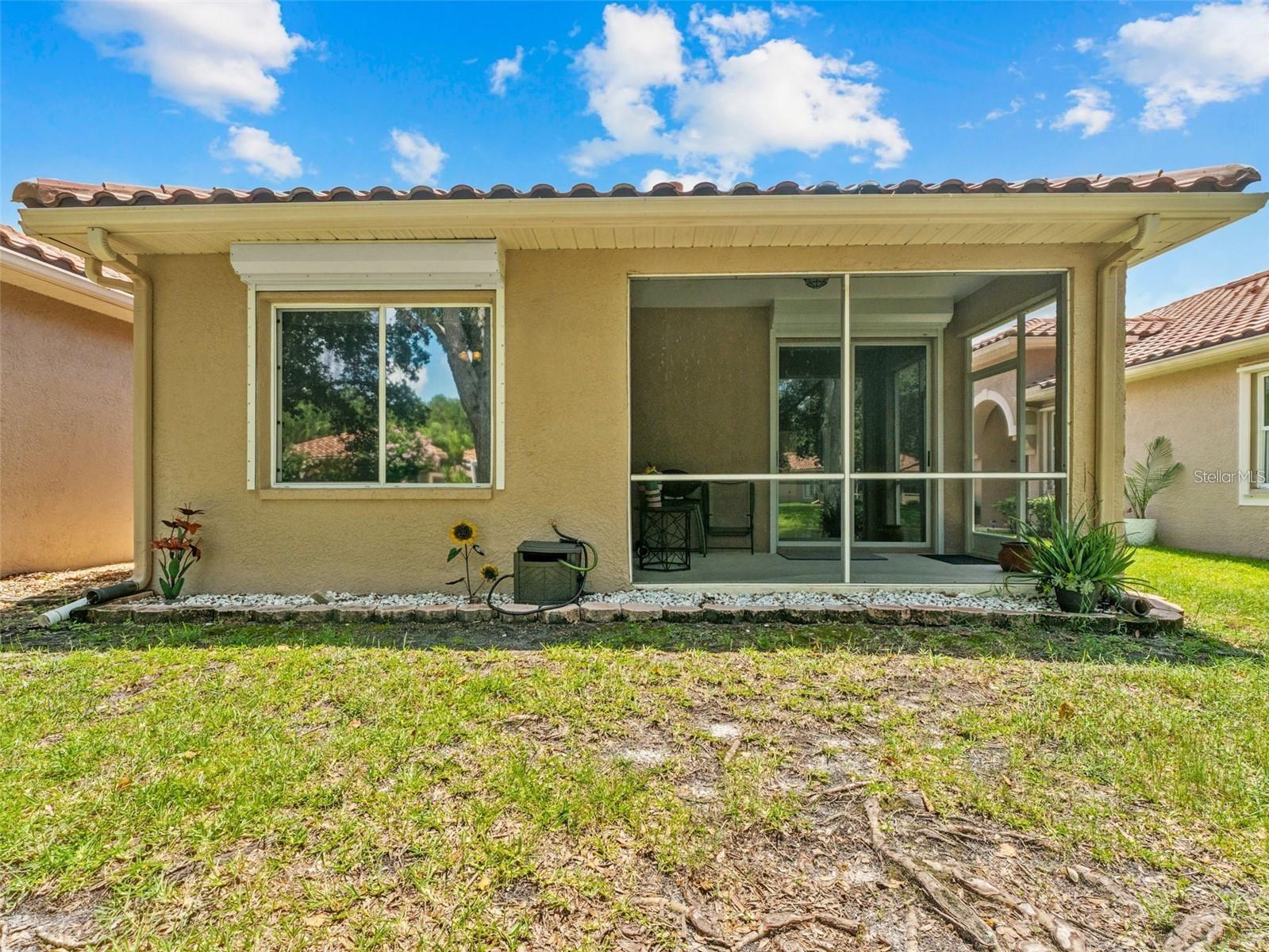 Back patio and primary bedroom window with hurricane roll down shutter for ultimate stress-free living