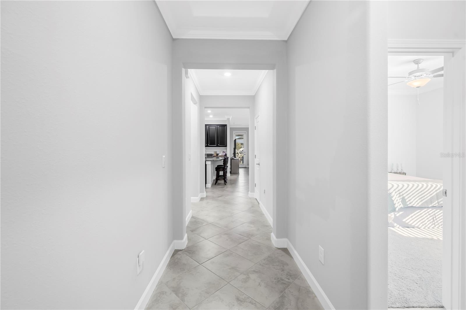 Entryway to the Heart of the Home with tray ceilings, high hats and interlaced crown molding